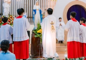 Group of clergy perform a religious ritual in a church setting.