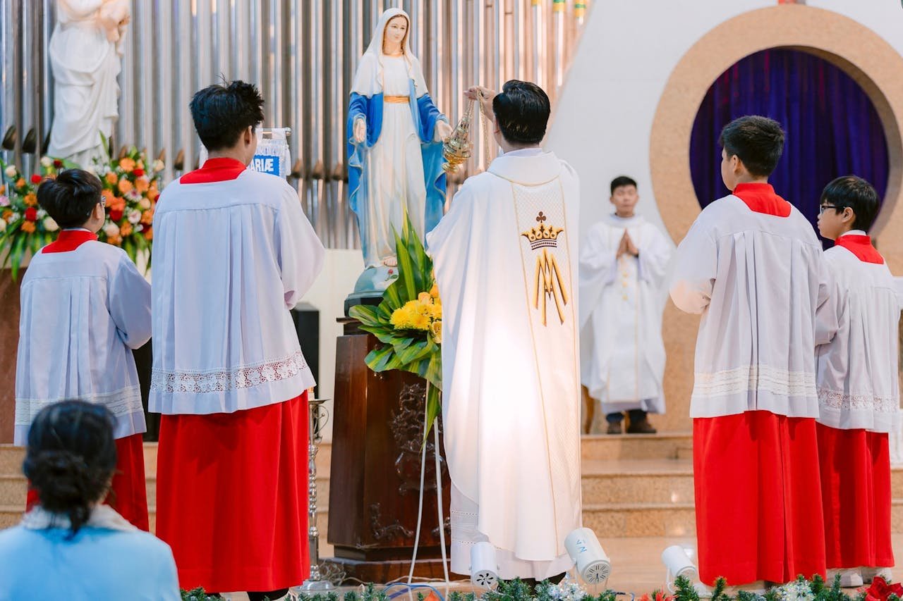 Group of clergy perform a religious ritual in a church setting.