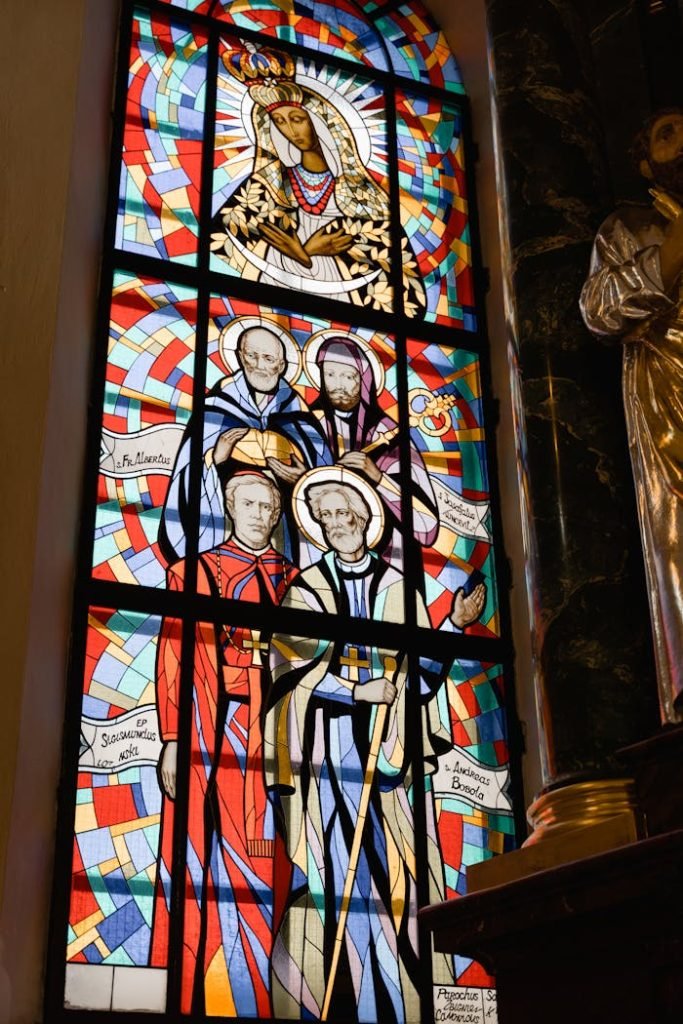 Colorful stained glass depicting religious figures in a church setting.